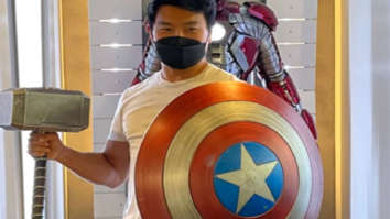 Shang-Chi’s Simu Liu strikes a pose with Captain America’s Shield & Thor’s Mjolnir at Marvel headquarters