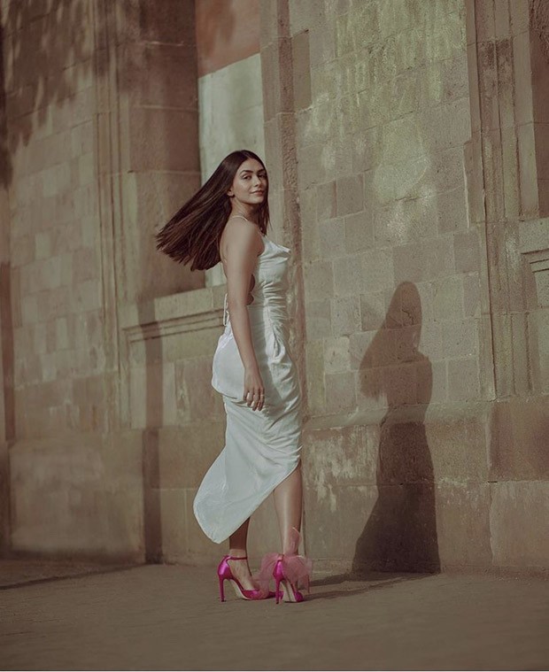 Mrunal Thakur looks pristine in white backless gown paired with Jimmy Choo fuchsia heels worth Rs. 69,545