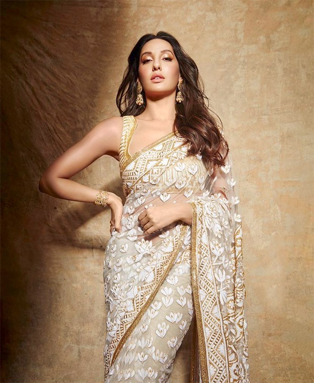 Nora Fatehi is a sight to behold in Manish Malhotra’s sheer floral ivory saree and sleeveless blouse