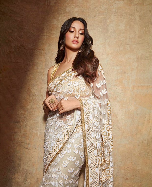 Nora Fatehi is a sight to behold in Manish Malhotra’s sheer floral ivory saree and sleeveless blouse