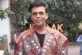Karan Johar poses in funky mirrored jacket