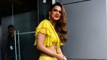Nia Sharma smiles brightly in yellow outfit and red lip